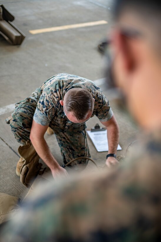 Sgt. Taylor Ngo, a civil affairs specialist with Special Purpose Marine Air-Ground Task Force - Southern Command, receives a gear inspection during a strategic mobility exercise at Marine Corps Air Station Cherry Point, North Carolina, May 29, 2020. SPMAGTF-SC Marines and Sailors conducted a MOBEX to validate the unit’s ability to rapidly and effectively deploy to Latin America and the Caribbean for crisis response efforts. The MOBEX will help the task force identify any resource shortfalls required to deploy from Camp Lejeune, North Carolina, to U.S. Southern Command’s area of operations, and give the service members an opportunity to demonstrate their ability to rapidly deploy at a moment’s notice. Ngo is a native of Los Angeles, California. (U.S. Marine Corps photo by Sgt. Andy O. Martinez)