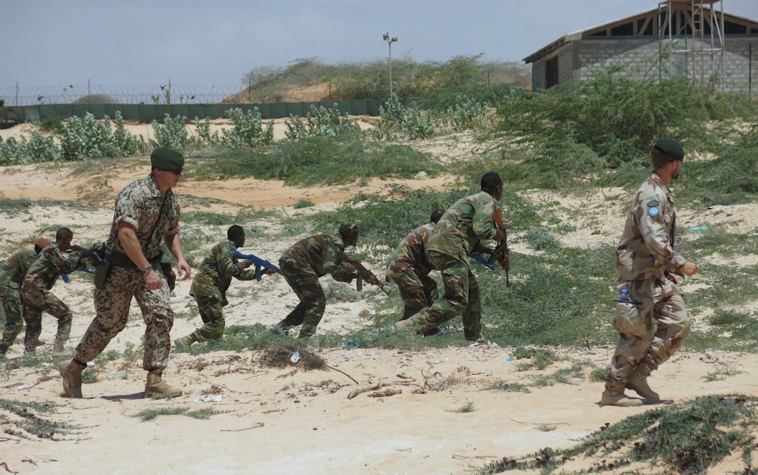 Instructors from the European Union Training Mission in Somalia (EUTM) take Somali National Army (SNA) soldiers through training drills at Jazeera Training Camp in Mogadishu. AMISOM (Raymond Baguma, 25 March 2015)