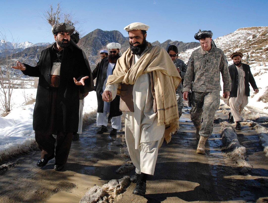 Paktia provincial Deputy Governor Abdal Rahma Mangal, left, talks with tribal leaders in the Jani Khel district during a visit to a remote village Feb. 15, 2009. (DoD photo by Fred W. Baker III)