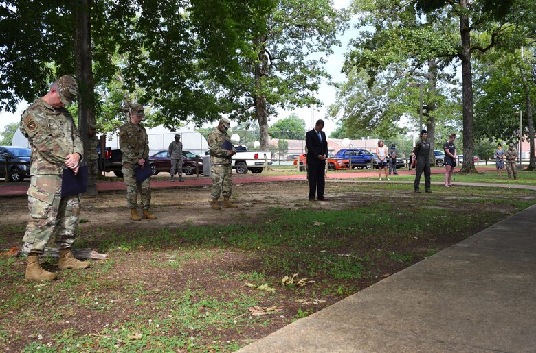 Members of Team Blaze bow their heads in prayer June 10, 2020, at Freedom Park on Columbus Air Force Base Miss. The members that were able to attend this event gathered in accordance to the COVID-19 guidelines for social distancing while still supporting each other during this difficult time. (U.S. Air Force photo by Senior Airman Jake Jacobsen)