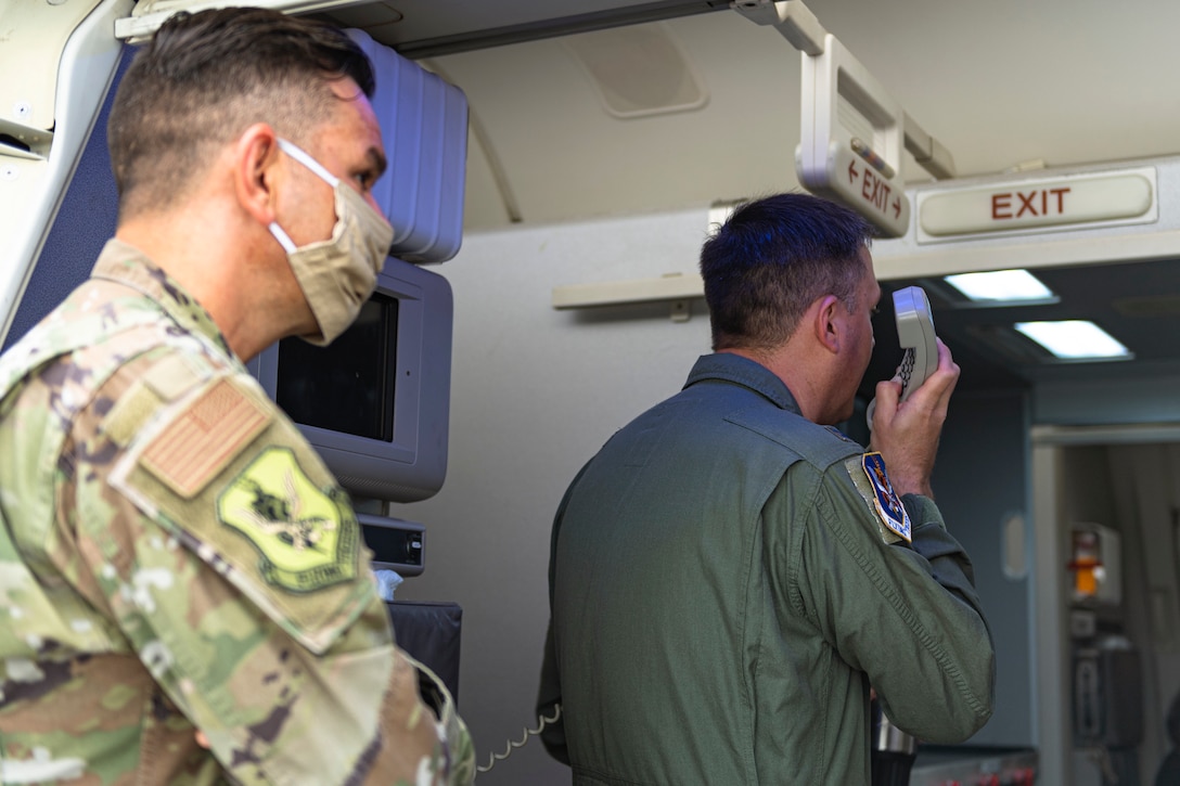 A photo of the 23d Wing commander and command chief talking to Airmen returning from a deployment