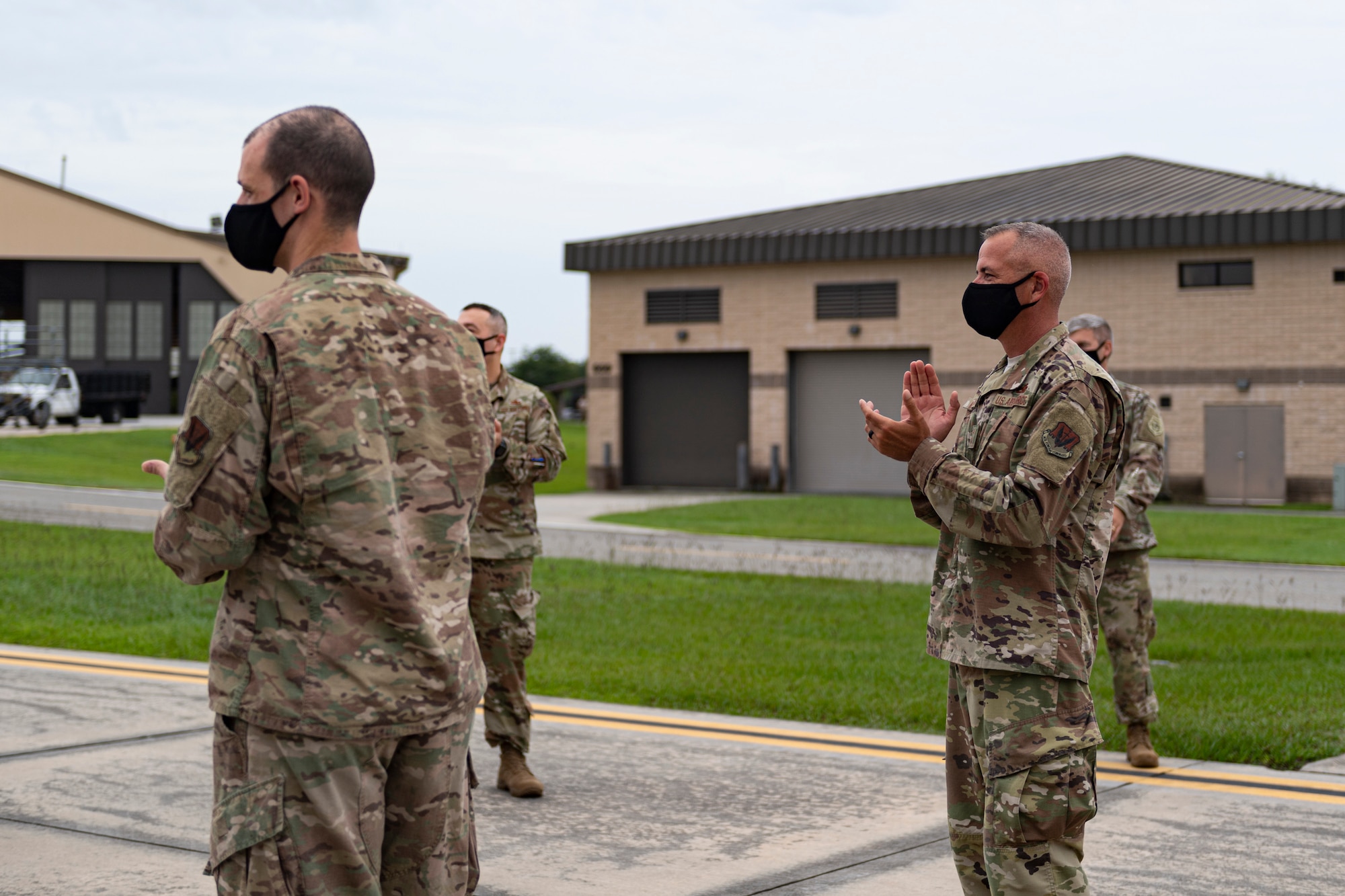 A photo of Airmen applauding Airmen returning from a deployment