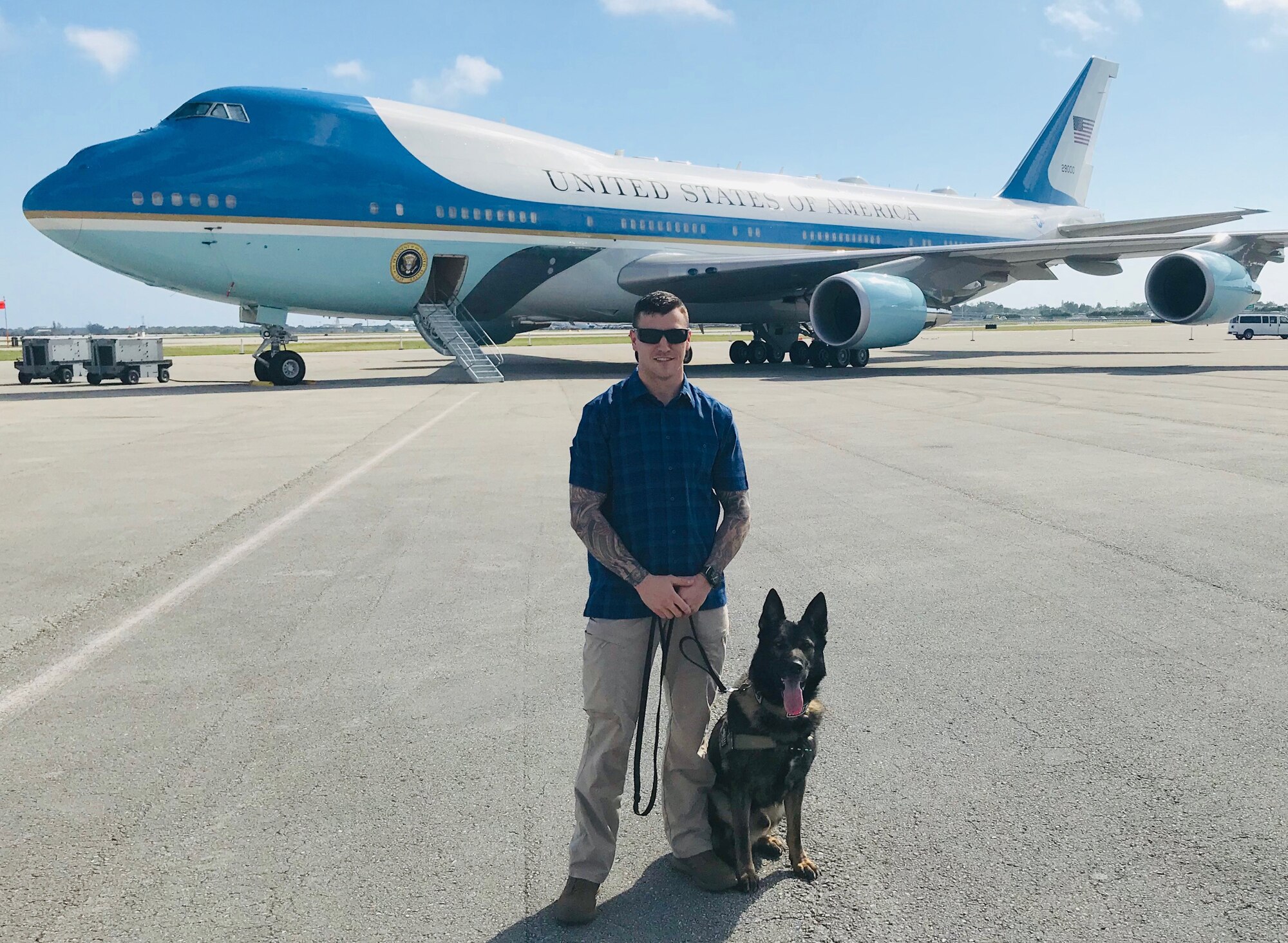 MAR-A-LAGO, Fla. – Staff Sgt. Danny Cohen, 21st Security Forces Squadron military working dog handler, and MWD Rexo, pose in front of Air Force One in Mar-A-Lago, Florida on Feb. 18, 2019. Cohen and Rexo were providing explosive detection for the United States presidential detail during their stay in Florida. (courtesy photo)