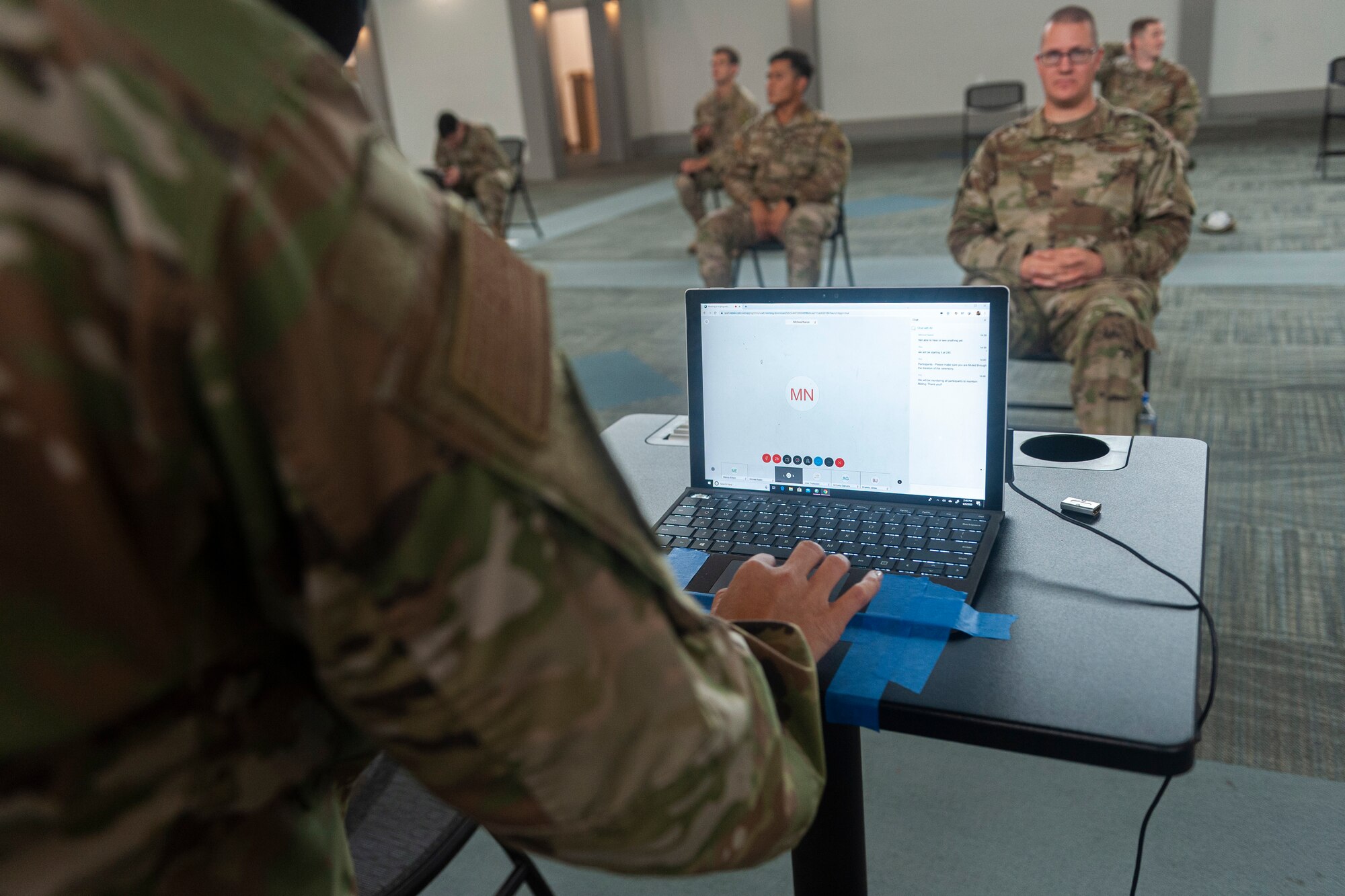 Photo of Airman setting up a laptop