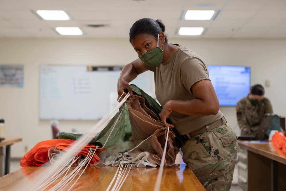 Aircrew Flight Equipment student separates parachute lines