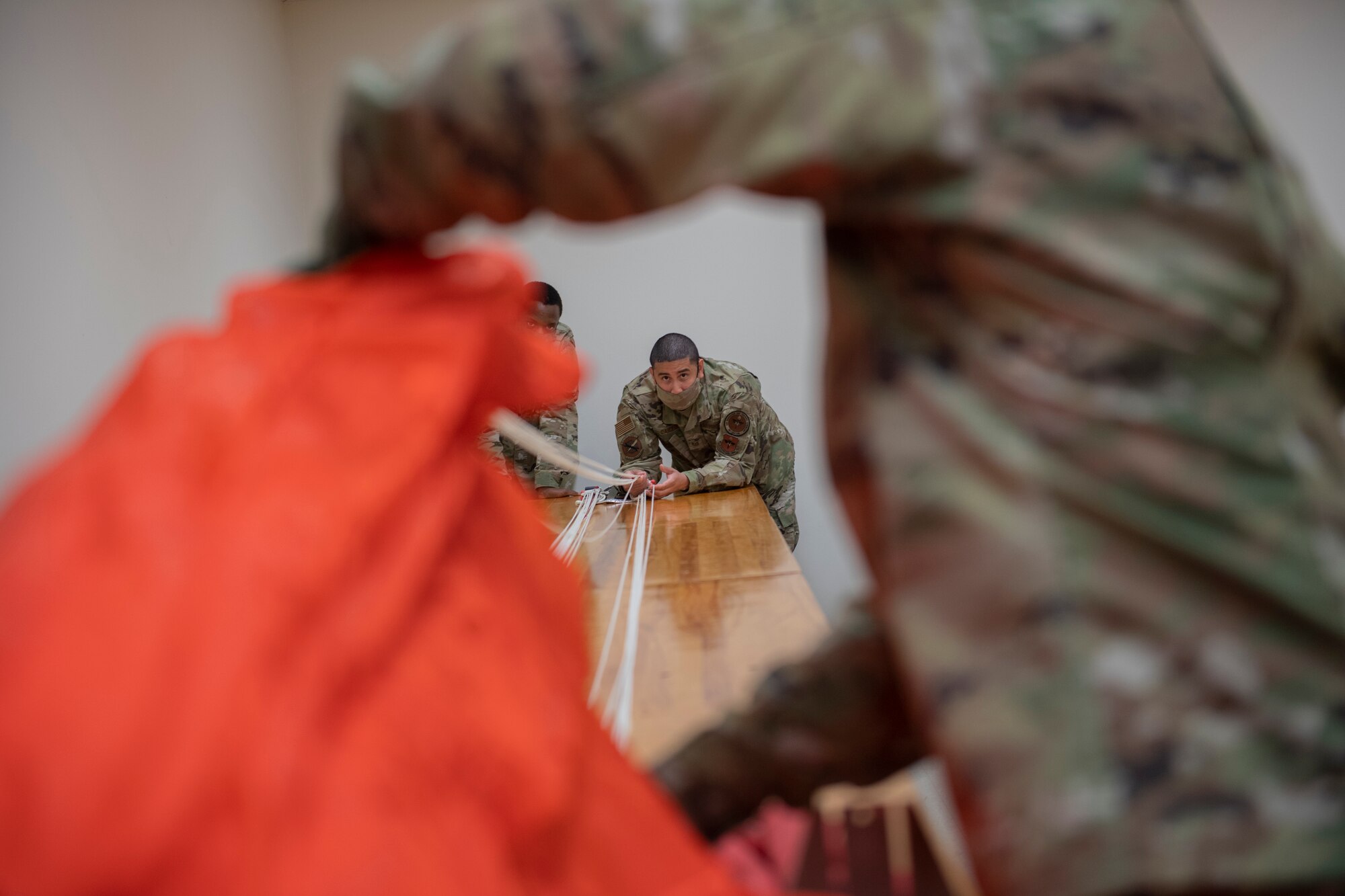 Aircrew Flight Equipment students work on a parachute