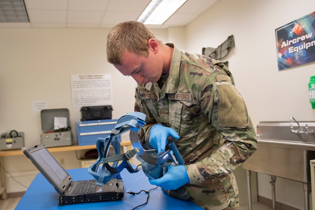 Aircrew Flight Equipment student inspects a quick don mask