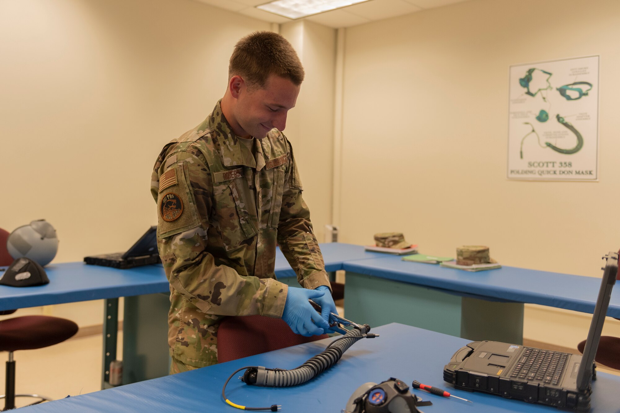 Aircrew Flight Equipment student assembles face mask oxygen hose