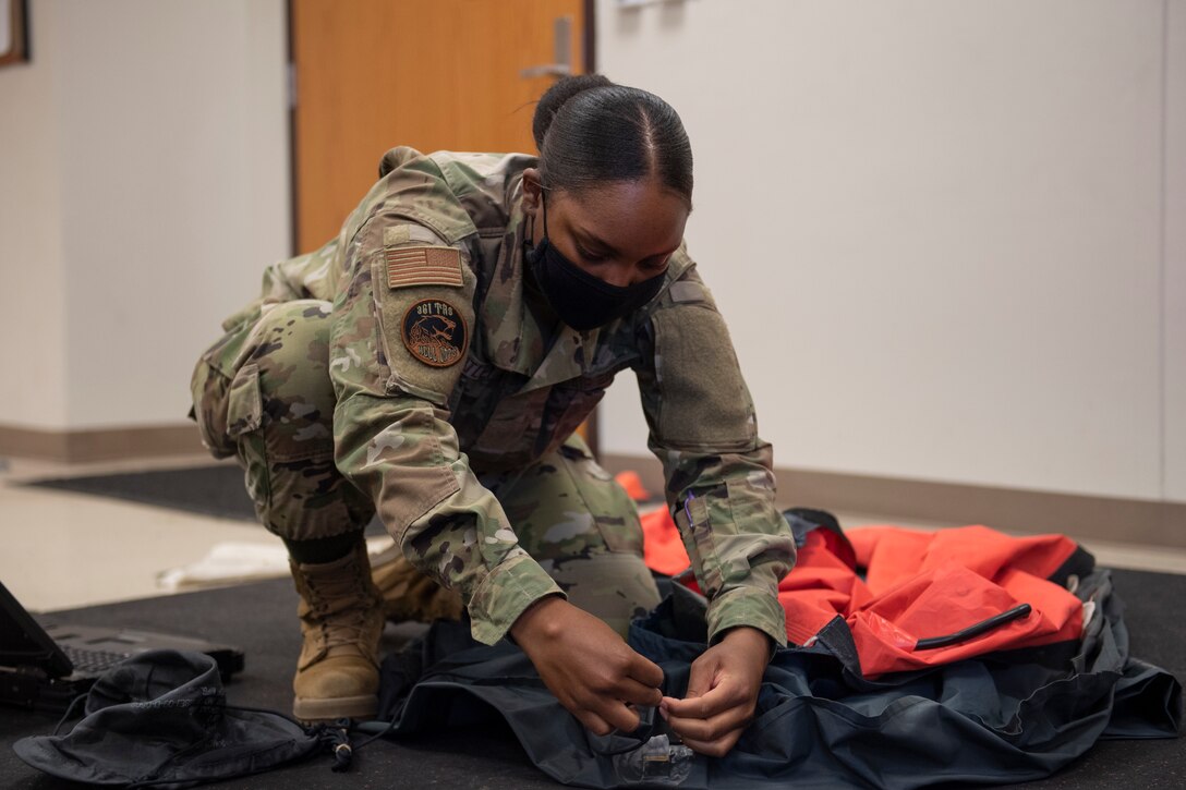 Aircrew Flight Equipment student works on life raft