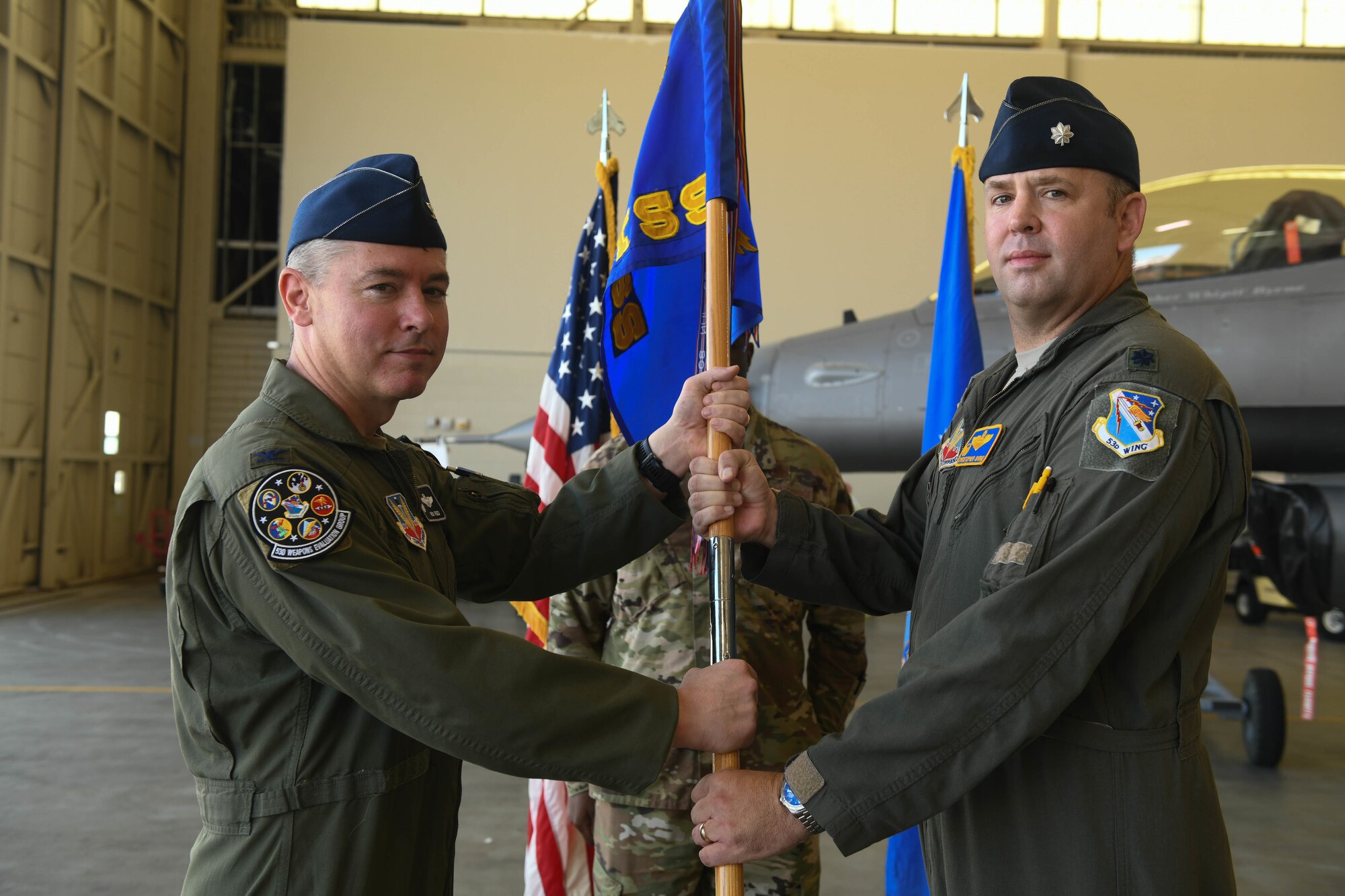 U.S. Air Force Lt. Col. Christopher Byrne, 53rd Test Support Squadron commander, right, assumes command from U.S. Air Force Col. Nicholas Reed, 53rd Weapons Evaluation Group commander, left, at Tyndall Air Force Base, Florida, on June 12, 2020. U.S. Air Force Senior Master Sgt. Shaun Barnette, 53rd Test Support Squadron superintendent, looks on. (U.S. Air Force photo by Airman Anabel Del Valle)