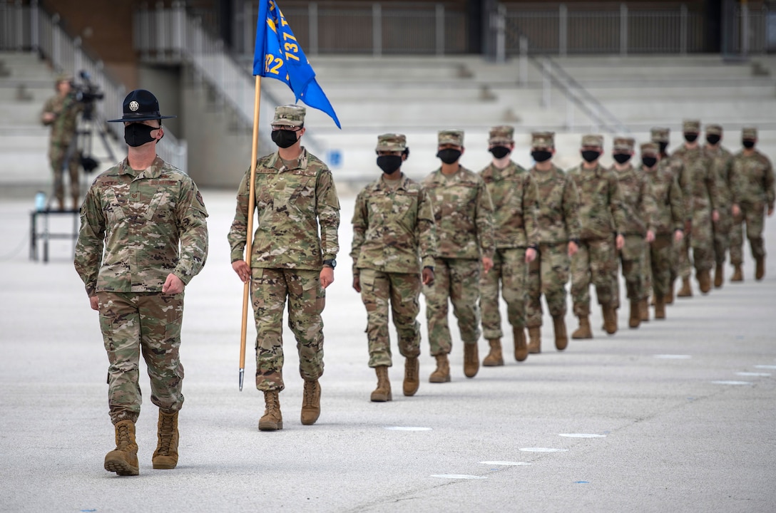 Instructors and trainees with the 322nd Training Squadron conduct an Air Force basic military  training graduation and coining ceremony June 4, 2020, at the Pfingston Reception Center on Joint Base San Antonio-Lackland, Texas. Due to COVID-19 restrictions, graduation ceremonies are closed to the public until further notice to ensure safety and security of the Airmen and their family members. (U.S. Air Force photo by Johnny Saldivar)