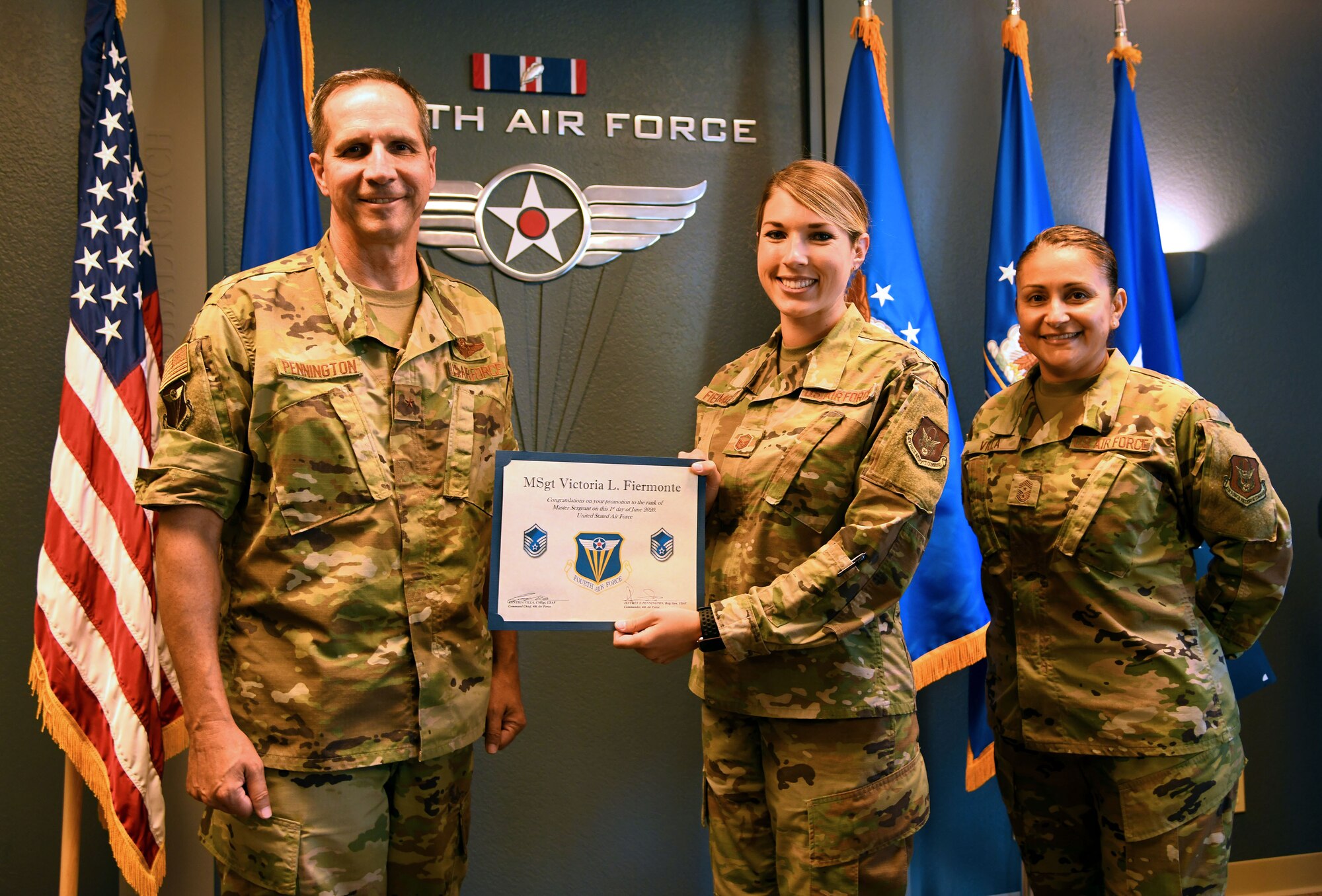 Brig. Gen. Jeffrey T. Pennington, Fourth Air Force commander, and Chief Master Sgt. Cynthia Villa, Fourth Air Force commander chief, (right), present Master Sgt. Victoria Fiermonte with her master sergeant promotion certificate. Fiermonte is executive assistant for the Fourth Air Force command chief. As the executive assistant, Fiermonte's responsibilities range from project management and travel arrangements to organizing teleconferences and event planning. (U.S. Air Force photo by Candy Knight)