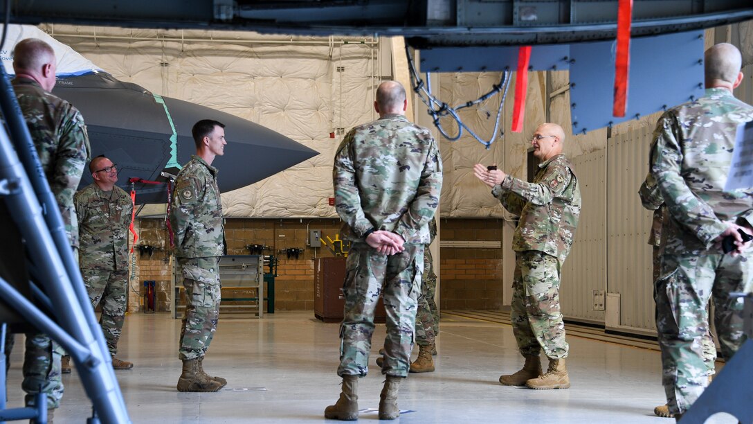 Gen. Bunch speaks with Airmen in an aircraft maintenance hangar from the 309th Expeditionary Depot Maintenance Flight.