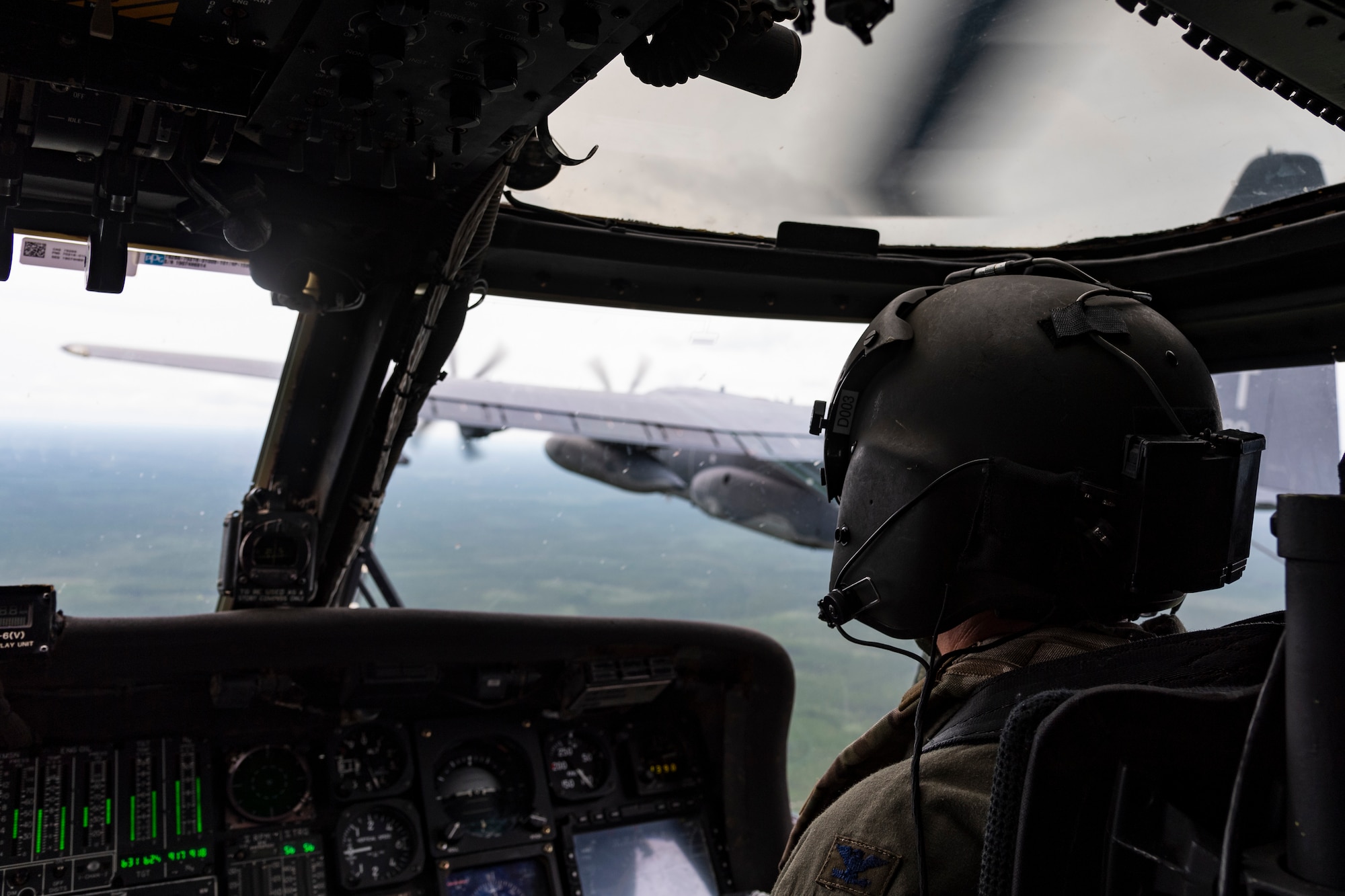 A photo of an Airman preparing for in-flight refueling
