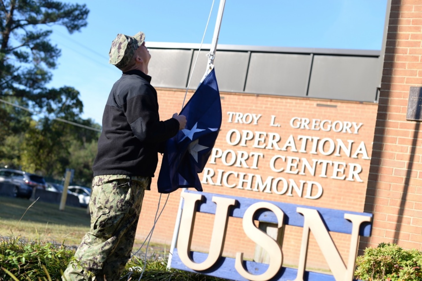 191019-N-YU482-0025 RICHMOND Va. (Oct. 19, 2019) Hull Technician 2nd Class Steven Story raises the rear admiral flag at Navy Operational Support Center Richmond for the visit of Commander, Navy Reserve Forces Command Rear Adm. John Schommer. The NOSC visit, Schommer's second as CNRFC, provided an opportunity to meet with Reserve Sailors, discuss Reserve force priorities, and answer questions. (U.S. Navy photo by Chief Mass Communication Specialist Stephen Hickok/Released)