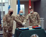 Master Sgt. Roger Townsend, an IT specialist assigned to New York National Guard Joint Force Headquarters, Brig. Gen. Michel Natali, the assistant adjutant general, Army, and Spc. Charles Fetzer, a military policeman assigned to the 104th Military Police Battalion, cut the U.S. Army birthday cake during a 245th Army birthday celebration at the Division of Military and Naval Affairs, Latham, N.Y., June 12th, 2020. The Army birthday is recognized each year with a cake cutting featuring the youngest Soldier, representing the future; the oldest Soldier representing wisdom and traditions; along with the commanding officer, though this year COVID-19 precautions were in place limiting the size of the event.