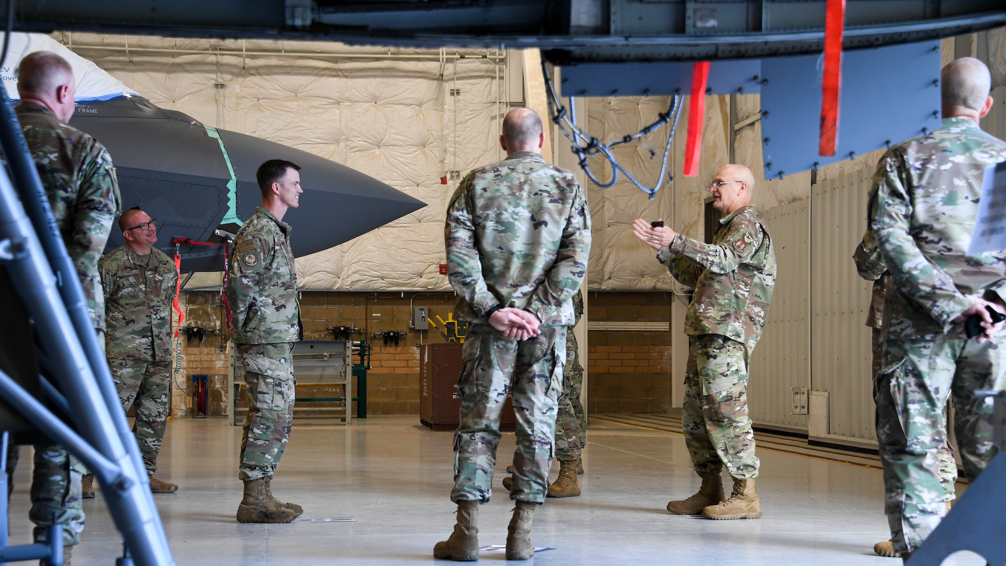Gen. Bunch speaks with Airmen in an aircraft maintenance hangar from the 309th Expeditionary Depot Maintenance Flight.