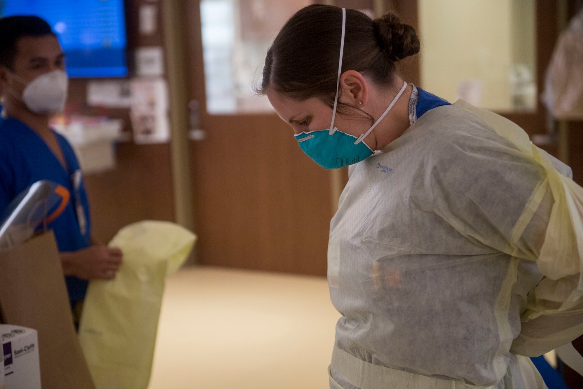Air Force Capt. Lisbeth Whaley, an emergency trauma nurse with Urban Augmentation Medical Task Force 811-1, dons personal protective equipment at Stamford Hospital-Bennett Medical Center, Stamford, Conn., May 14, 2020. U.S. Northern Command, through U.S. Army North, remains committed to providing flexible Department of Defense support to the Federal Emergency Management Agency for the whole-of-nation COVID-19 Response. (U.S. Air Force photo by Senior Airman Nicholas Dutton)