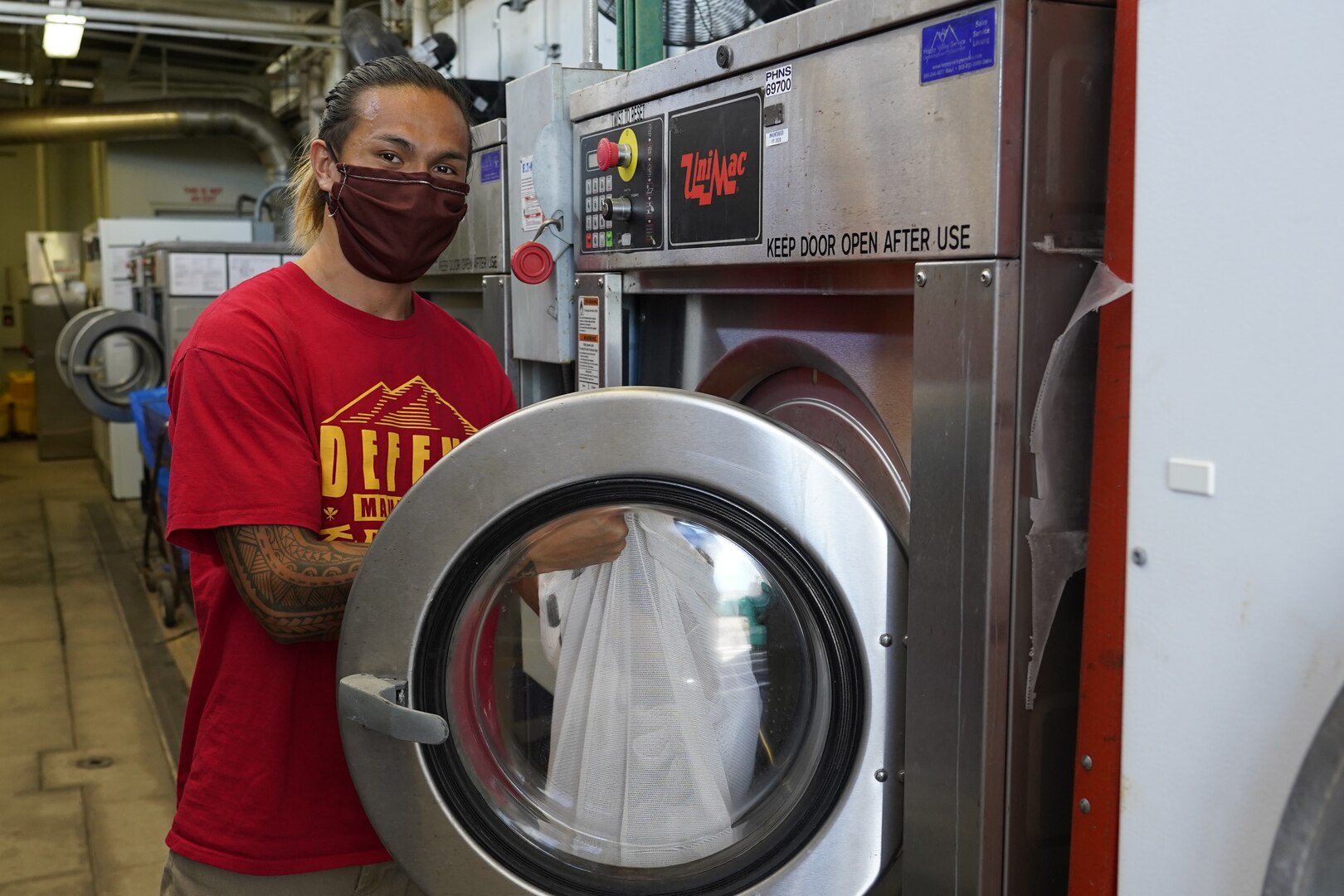 Shop 06 Tool Room Helper is washing a batch of safety coverings to be distributed to the workforce.
