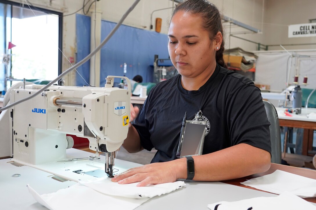 Shop 64A Fabric Worker manufactures a safety covering to be distributed to the workforce.