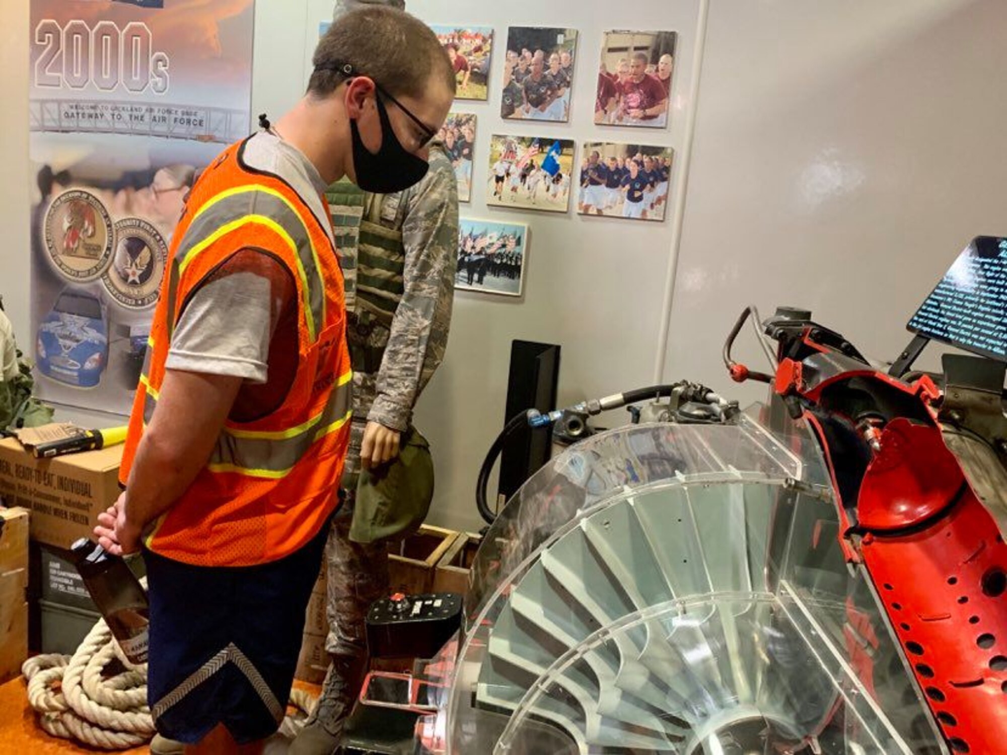 Photo of basic military training trainees interacting with an exhibit  in the Airman Heritage Museum.