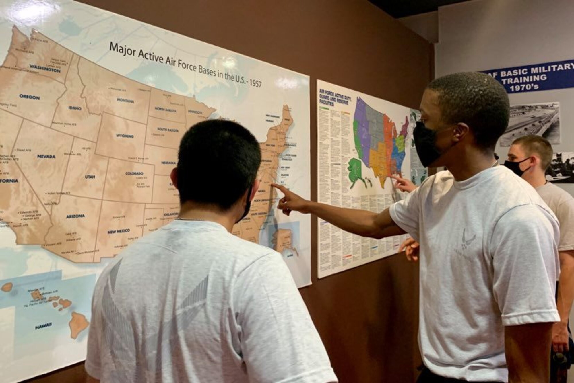 Photo of basic military training trainees interacting with an exhibit  in the Airman Heritage Museum.