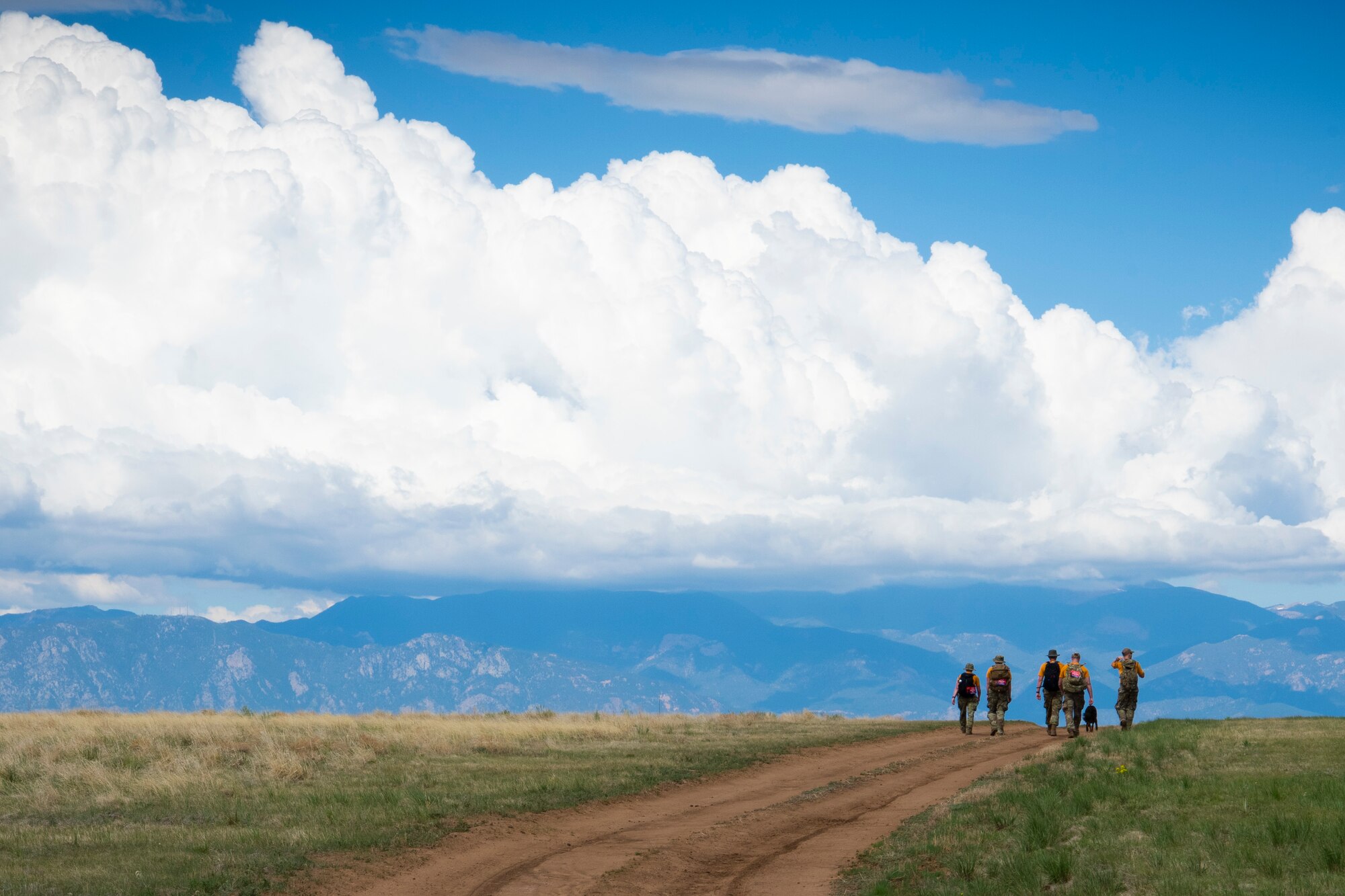 Airmen march on the base perimeter at Schriever Air Force Base, Colo., May 28, 2020, during their substitute Bataan Memorial Death March. Airmen on Schriever AFB decided to host their own march on base after the original annual event held at White Sands Missile Range, N.M., was cancelled due to COVID-19. (U.S. Air Force photo by Airman 1st Class Jonathan Whitely)