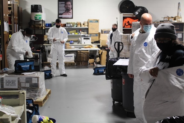 Members of the 480th Intelligence, Surveillance, and Reconnaissance Wing Emergency Management’s cleaning team puts on their protective gear May 29, 2020 at Joint Base Langley-Eustis, Va. The EM team developed parameters and cleaning teams to perform trace cleanings to prevent any additional COVID-19 exposures within the building.