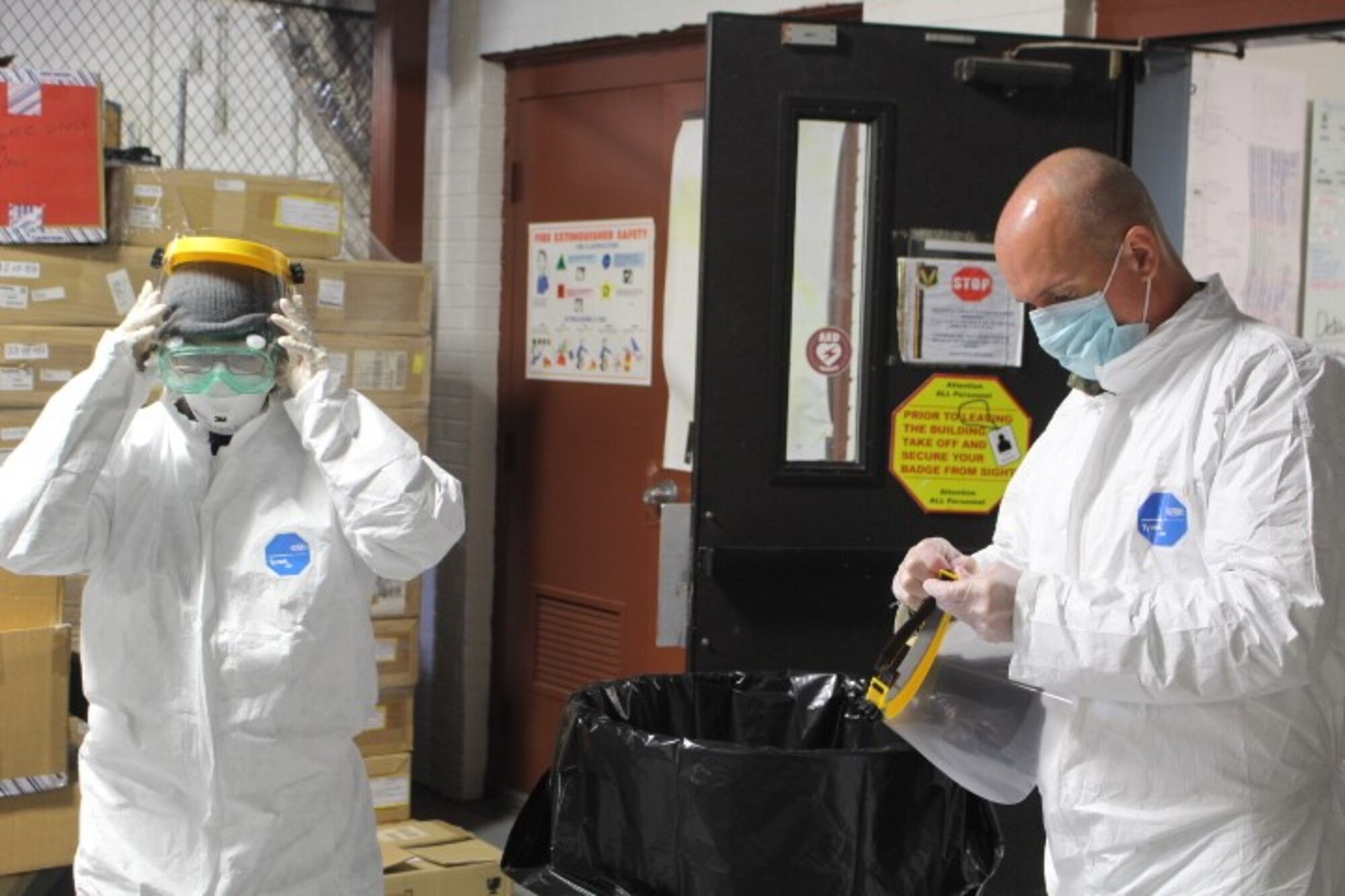 Members of the 480th Intelligence, Surveillance, and Reconnaissance Wing Emergency Management’s cleaning team puts on their protective gear May 29, 2020 at Joint Base Langley-Eustis, Va. The EM team developed parameters and cleaning teams to perform trace cleanings to prevent any additional COVID-19 exposures within the building.