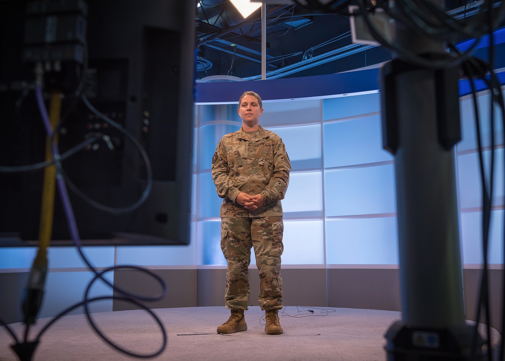 Tech. Sgt. Renee Wiederspahn, a Lankford Enlisted Professional Military Education professional military training instructor, prepares to read from a teleprompter at the TEC television studios in East Tennessee, June 4, 2020, during a recording session for virtual in-residence enlisted education. The center kicks off virtual-in-residence-remote Noncomissioned Officer Academy and Airman Leadership School for the Air Force this month. (U.S. Air National Guard photo by Master Sgt. Mike R. Smith)