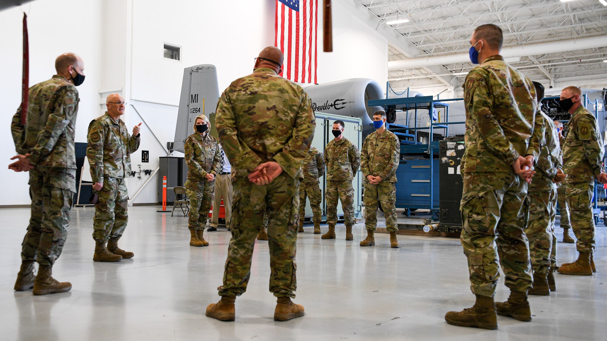 Gen. Bunch is addressing Airmen standing in an aircraft maintenance hangar from the 309th Expeditionary Depot Maintenance Flight.