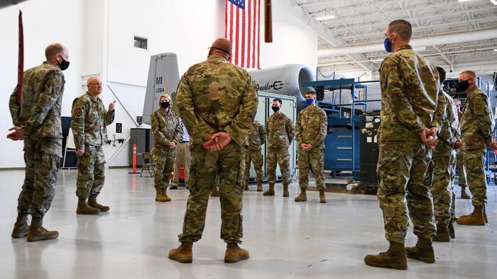 Gen. Bunch is addressing Airmen standing in an aircraft maintenance hangar from the 309th Expeditionary Depot Maintenance Flight.