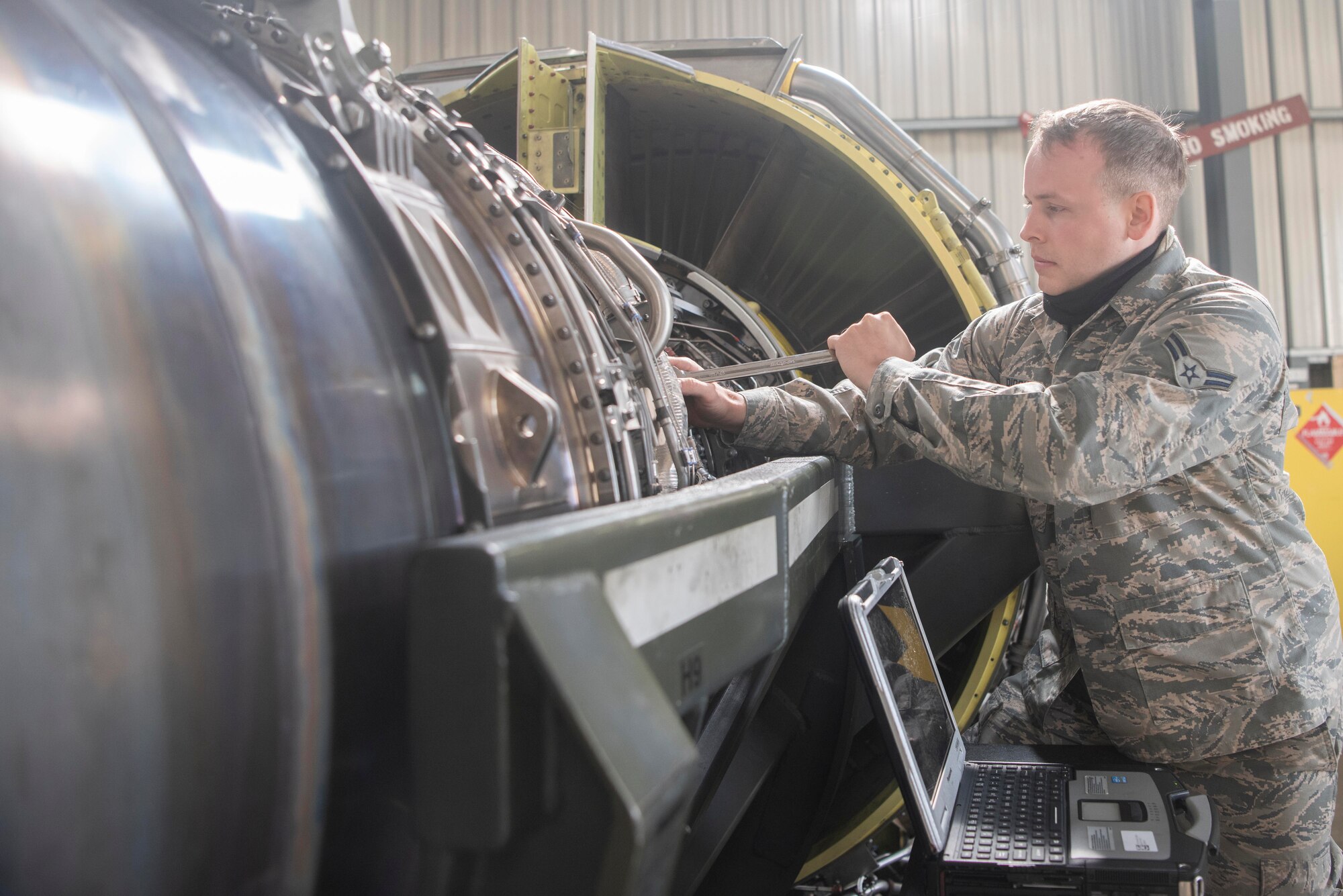 Airman 1st Class Eric Ridout, 100th Aircraft Maintenance Squadron aerospace propulsion apprentice, tightens a bolt on an F108 turbofan engine at RAF Mildenhall, England, June 9, 2020. In addition to repairing engines, the shop conducts periodic maintenance inspections after a certain number of flight hours. (U.S. Air Force photo by Airman 1st Class Joseph Barron)