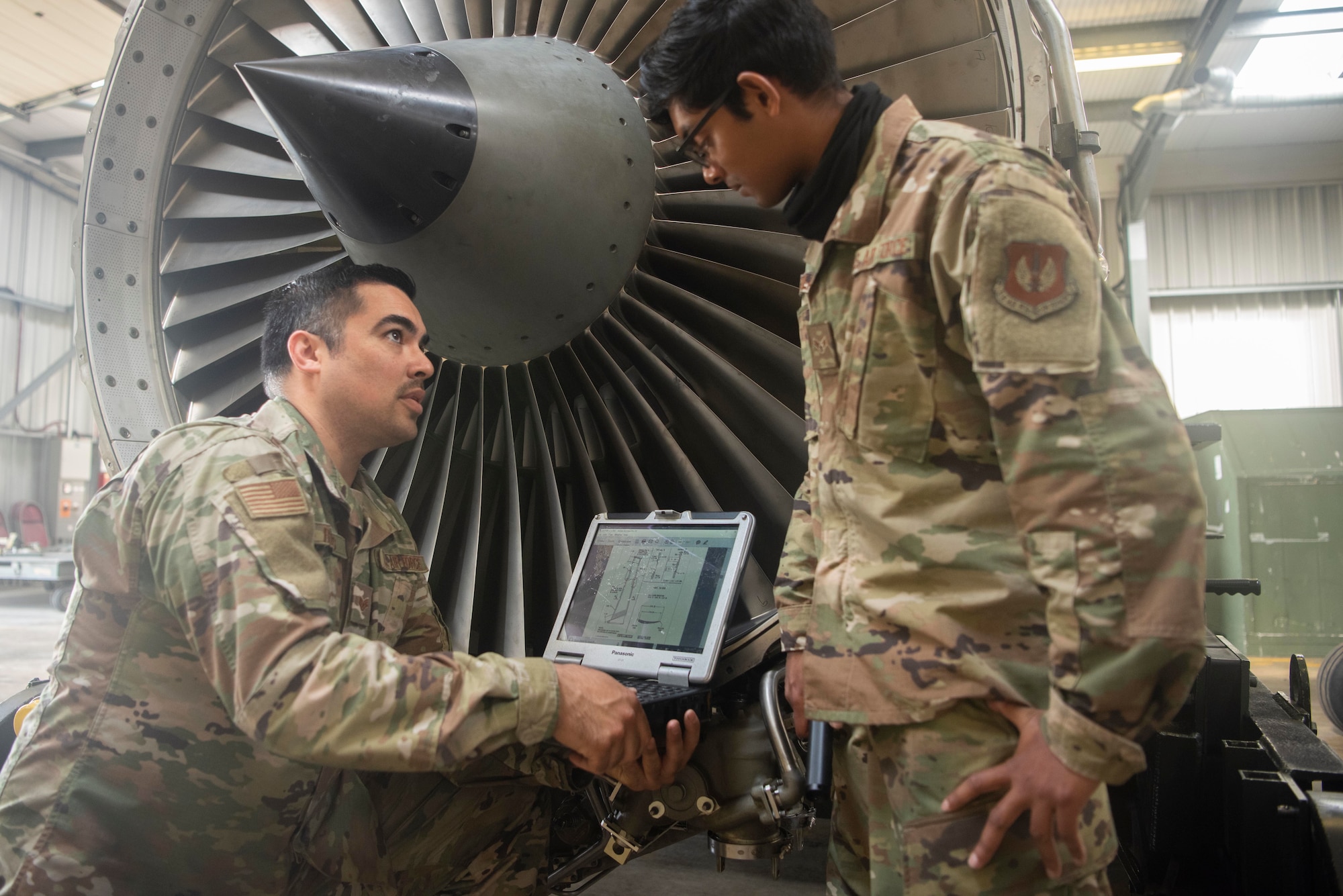 Staff Sgt. Ernesto Rojas (left), 100th AMXS aerospace propulsion craftsman, and Airman 1st Class Rajendra Harilall (right), 100th Aircraft Maintenace Squadron aerospace propulsion journeyman, discuss a maintenance issue at RAF Mildenhall England, June 9, 2020. Engine expertise is developed through years of hands-on experience troubleshooting engine issues. (U.S. Air Force photo by Airman 1st Class Joseph Barron)