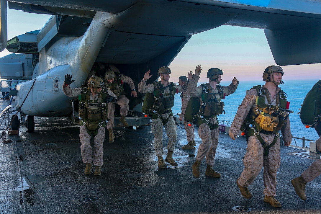 200506-M-IR130-1060 ARABIAN GULF (May 6, 2020) Reconnaissance Marines assigned to the Maritime Raid Force, 26th Marine Expeditionary Unit (MEU), walk through the procedures of a free-fall insert aboard the amphibious assault ship USS Bataan May 6, 2020. Bataan, with embarked 26th MEU, is deployed to the U.S. 5th Fleet area of operations in support of naval operations to ensure maritime stability and security in the Central Region, connecting the Mediterranean and Pacific through the Western Indian Ocean and three strategic choke points. (U.S. Marine Corps photo by Cpl. Gary Jayne III)