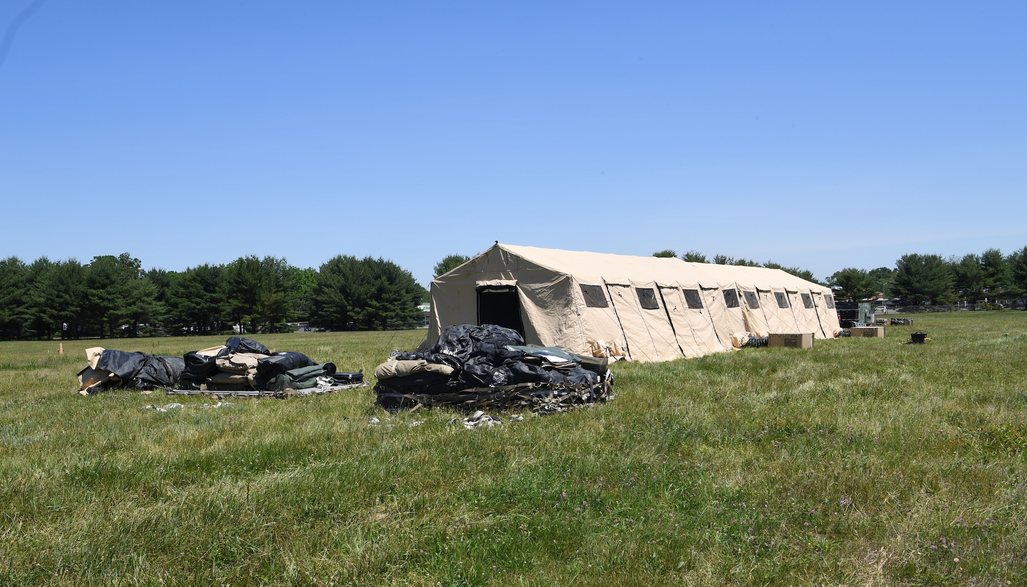 The Tactical Operations Center tent houses members of the 621st Contingency Response Wing during a readiness exercise June 9, 2020, at Joint Base McGuire-Dix-Lakehurst, New Jersey. The exercise was developed to demonstrate the capability to operate and exercise during COVID-19 conditions while also accomplishing advanced training requirements for Airmen. (U.S. Air Force photo by Tech. Sgt. Luther Mitchell)