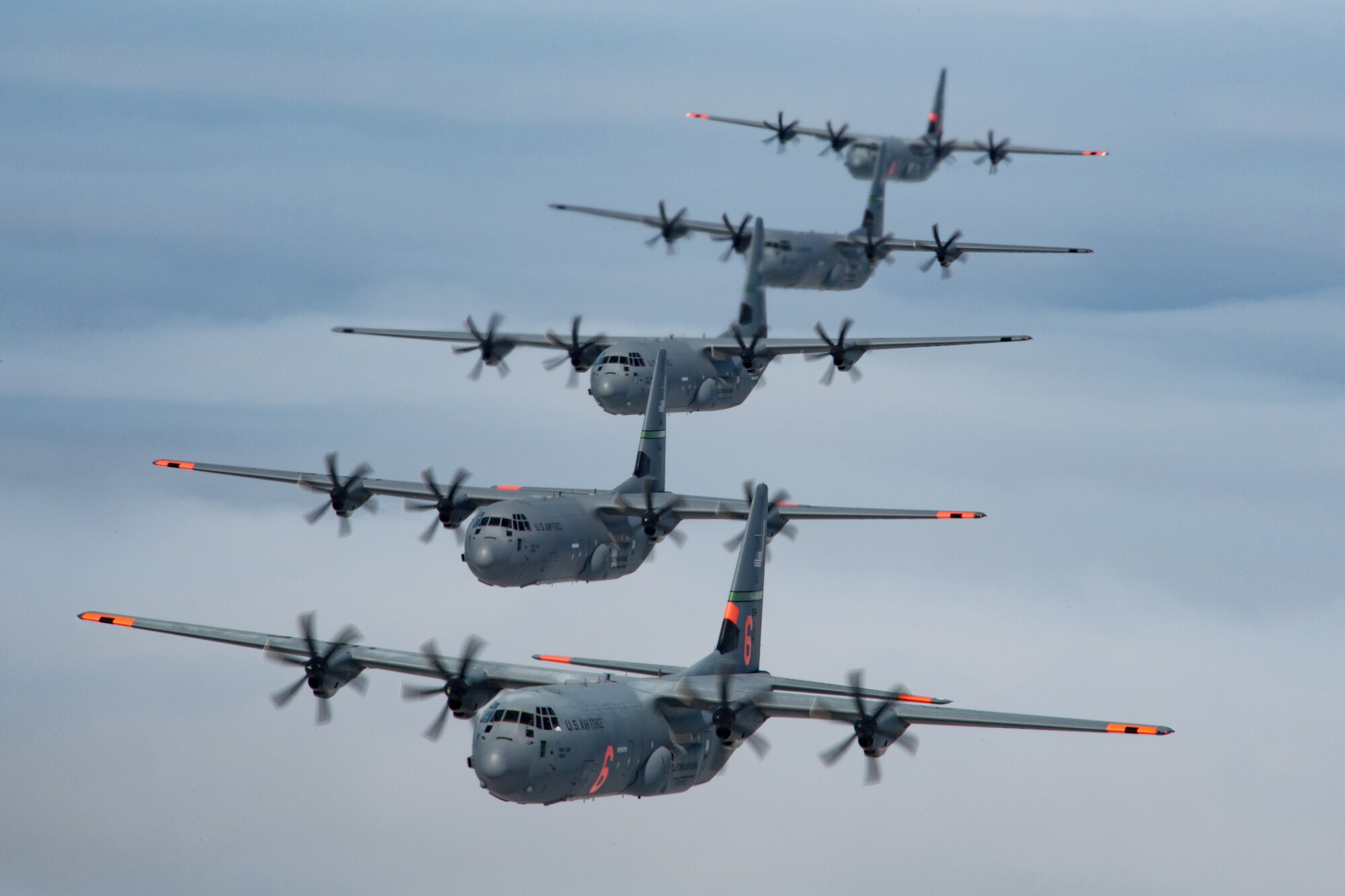 5 (of 6) California Air National Guard C-130J Super Hercules aircraft fly in tight formation over the Pacific Ocean, California. May 27, 2020. California Air National Guard maintainers from the 146th Maintenance Group and aircrew from the 115th Airlift Squadron, collaborated to accomplish the launching of 6 C-130J Super Hercules aircraft for the first time in over 20 years U.S. Air National Guard by Tech. Sgt. Nieko Carzis.