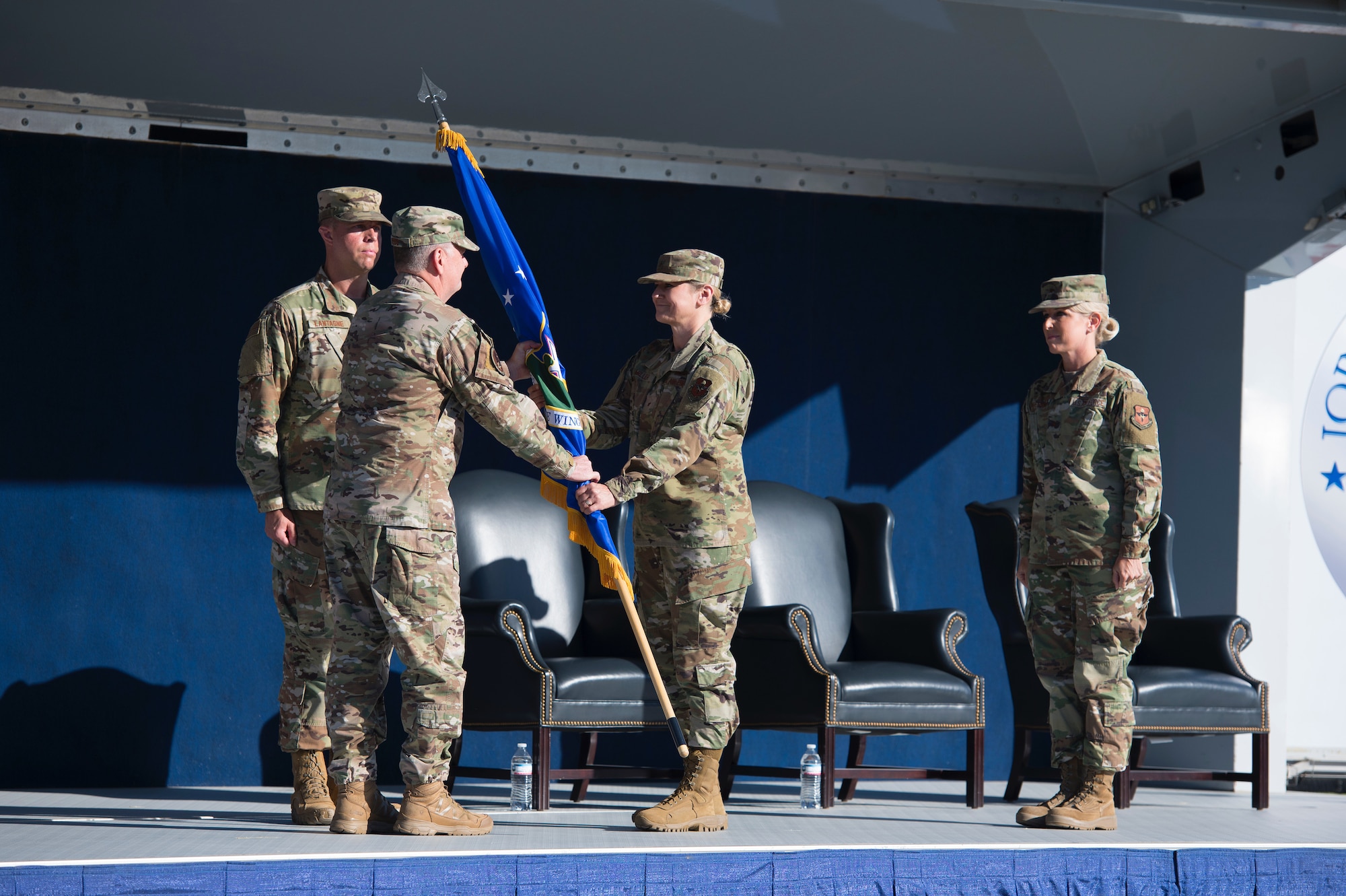 Lt. Gen. Brad Webb, the Air Education and Training Command commander, passes the 502d Air Base Wing colors to Brig. Gen. Caroline Miller, the newest commander of the wing and Joint Base San Antonio during a modified ceremony June 12 at JBSA-Fort Sam Houston, Texas.