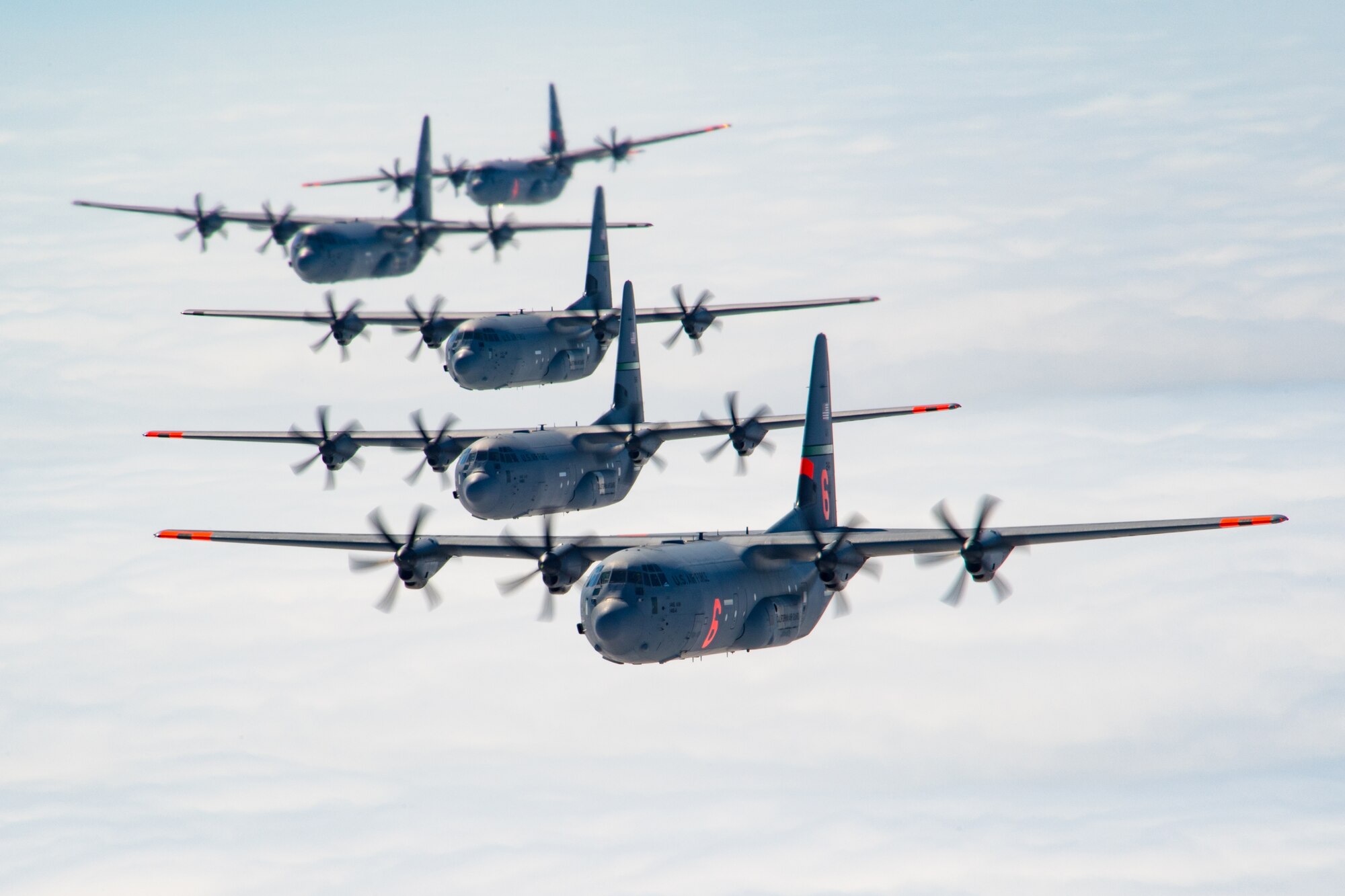 5 of 6 California Air National Guard C-130J Super Hercules aircraft fly in tight formation over the Pacific Ocean, California. May 27, 2020. California Air National Guard maintainers from the 146th Maintenance Group and aircrew from the 115th Airlift Squadron, collaborated to accomplish the launching of 6 C-130J Super Hercules aircraft for the first time in over 20 years U.S. Air National Guard by Tech. Sgt. Nieko Carzis.