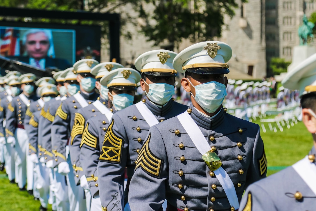 Cadets march out onto a parade field.