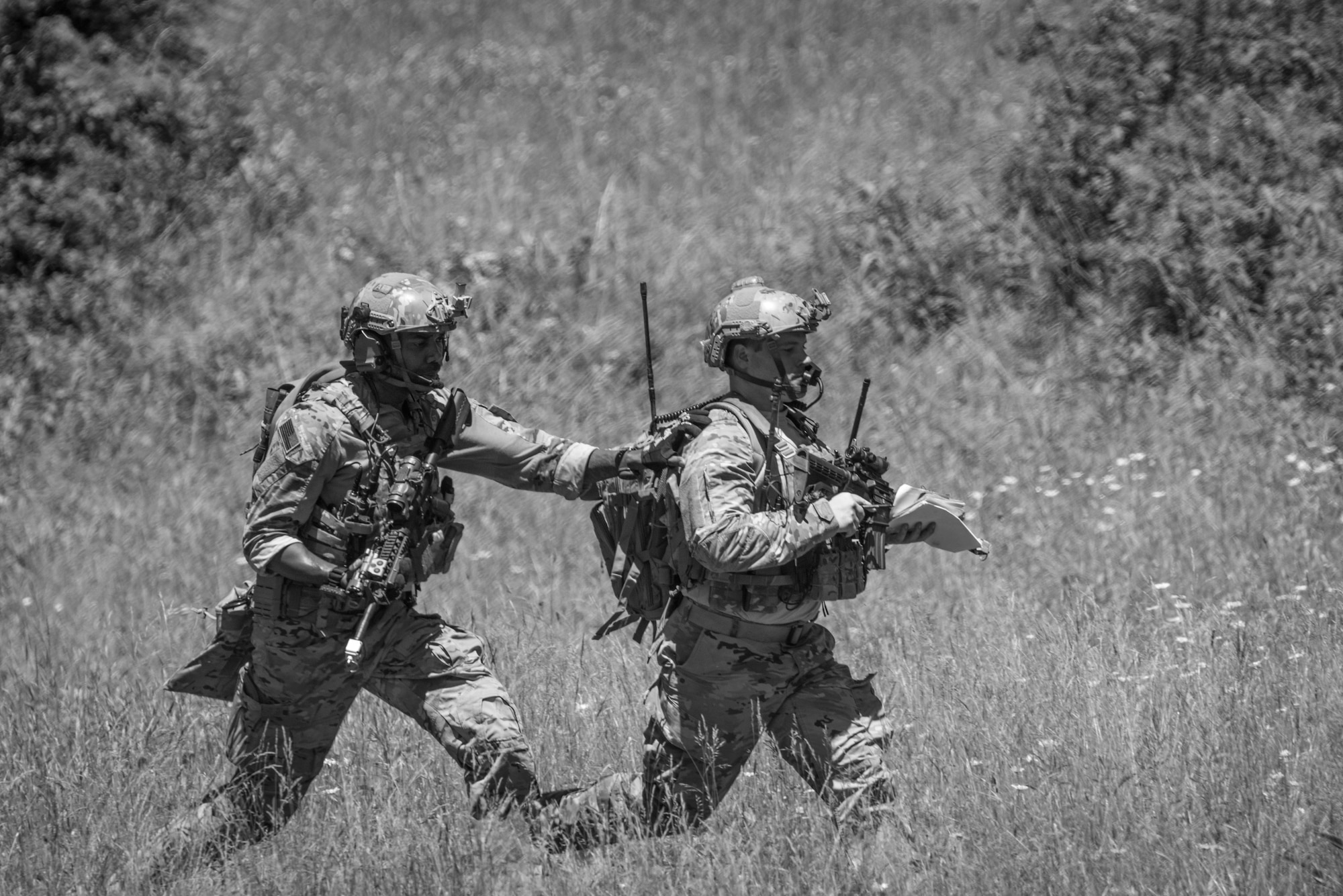 U.S. Air Force Staff Sgt. Kerry Martin, left, and Senior Airman Anthony Severo, both Joint Terminal Attack Controllers from the 148th Air Support Operations Squadron, Pennsylvania Air National Guard, bound to their next objective during a training exercise, June 13, 2020, in Annville, Pennsylvania.