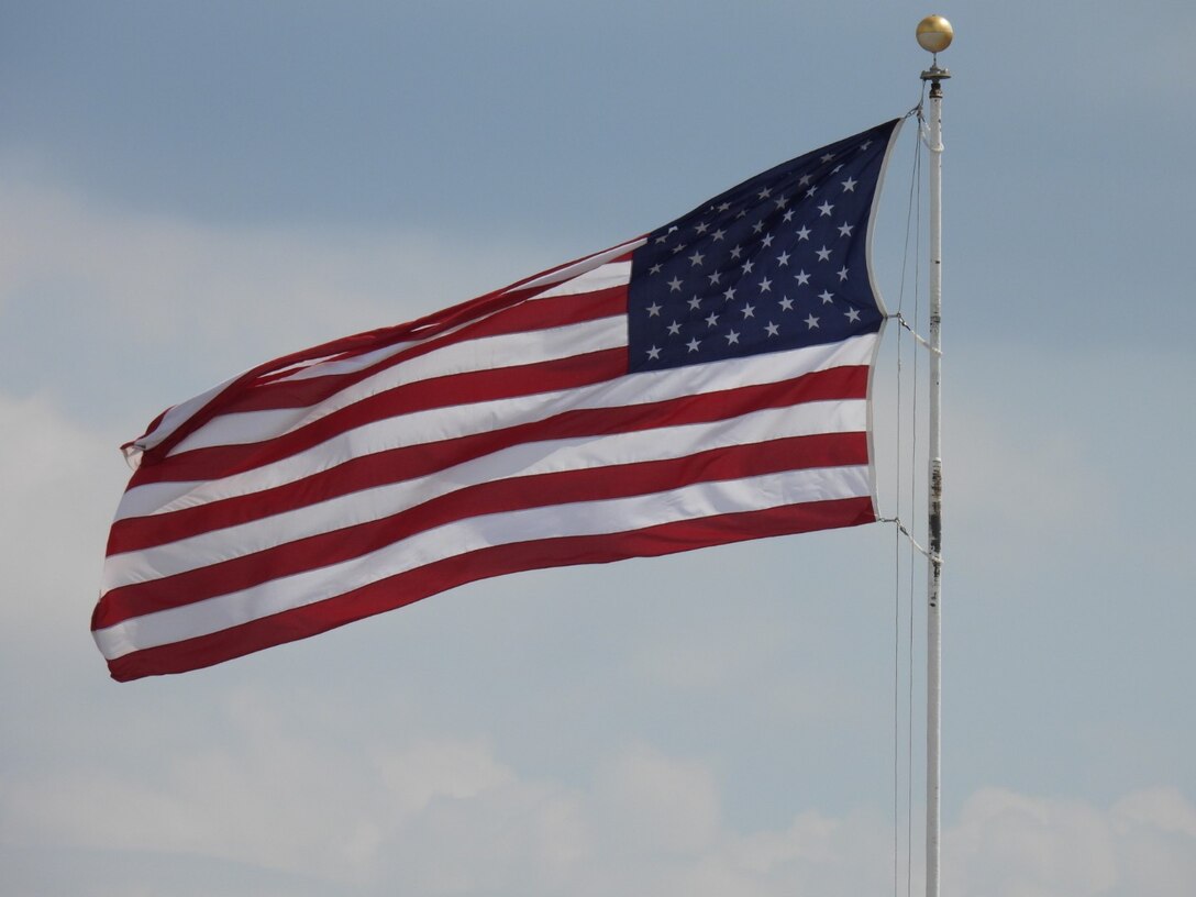 The United States flag flying in front of Bldg. 3001 at Tinker Air Force Base, Oklahoma. (Air Force photo by April McDonald)
