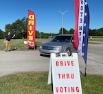 Kentucky National Guard Chief Warrant Officer 2 David Cureton directs traffic through a drive-through voting station in Lawrenceburg June 12, 2020. Guard members serving in civilian clothes are helping fill in for volunteers for the June 23 primary, setting up and cleaning poll locations and assisting with traffic, parking and crowd control.