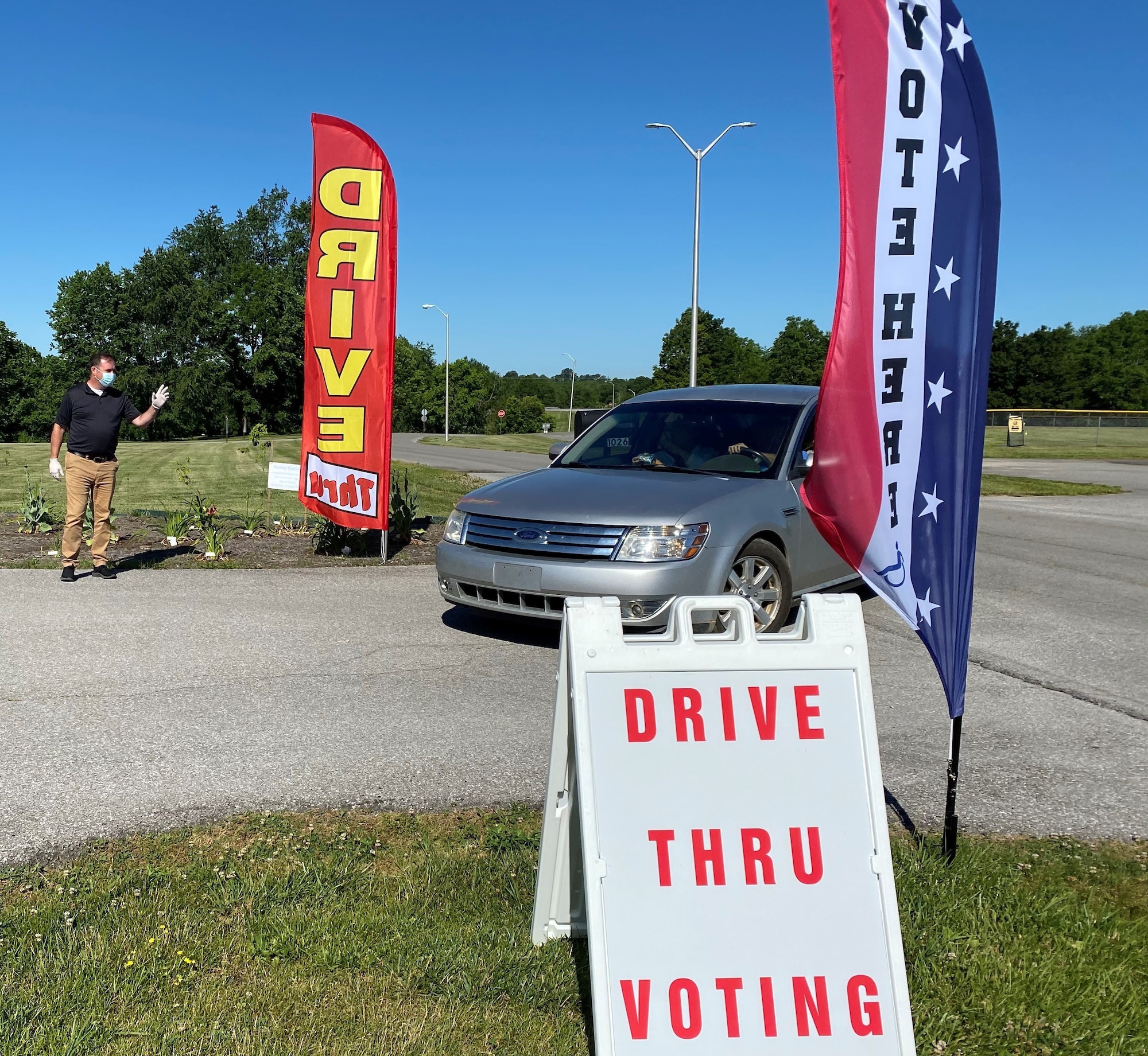 Kentucky National Guard Chief Warrant Officer 2 David Cureton directs traffic through a drive-through voting station in Lawrenceburg June 12, 2020. Guard members serving in civilian clothes are helping fill in for volunteers for the June 23 primary, setting up and cleaning poll locations and assisting with traffic, parking and crowd control.