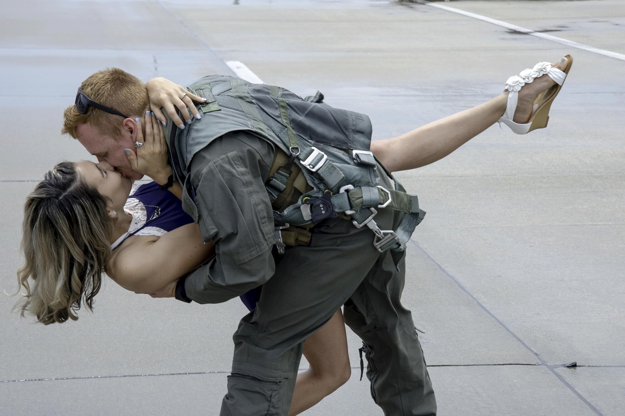 Photo of a pilot kissing his wife.