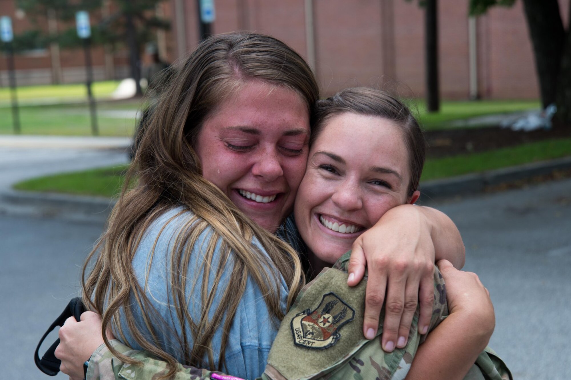 A service member embraces a family member.