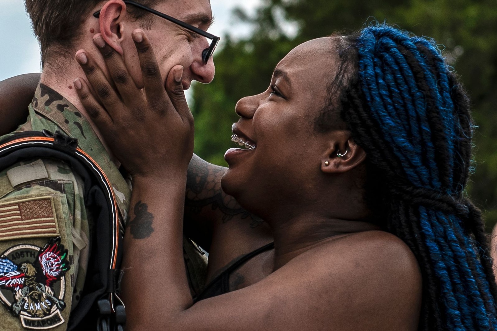 Photo of a Team Shaw spouse smiling and holding her service member's face.