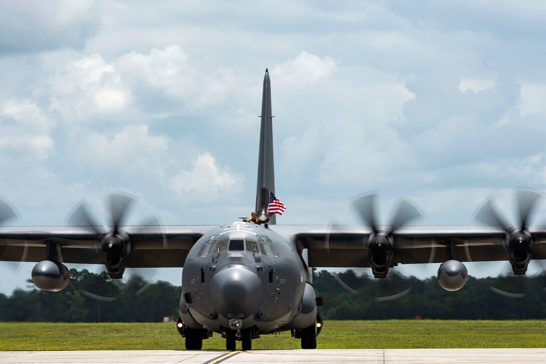 Photo of Airman waving a flag.