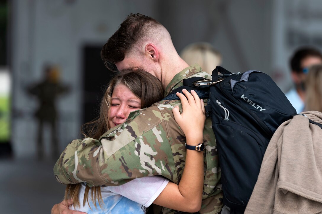 Photo of Airman hugging his daughter.