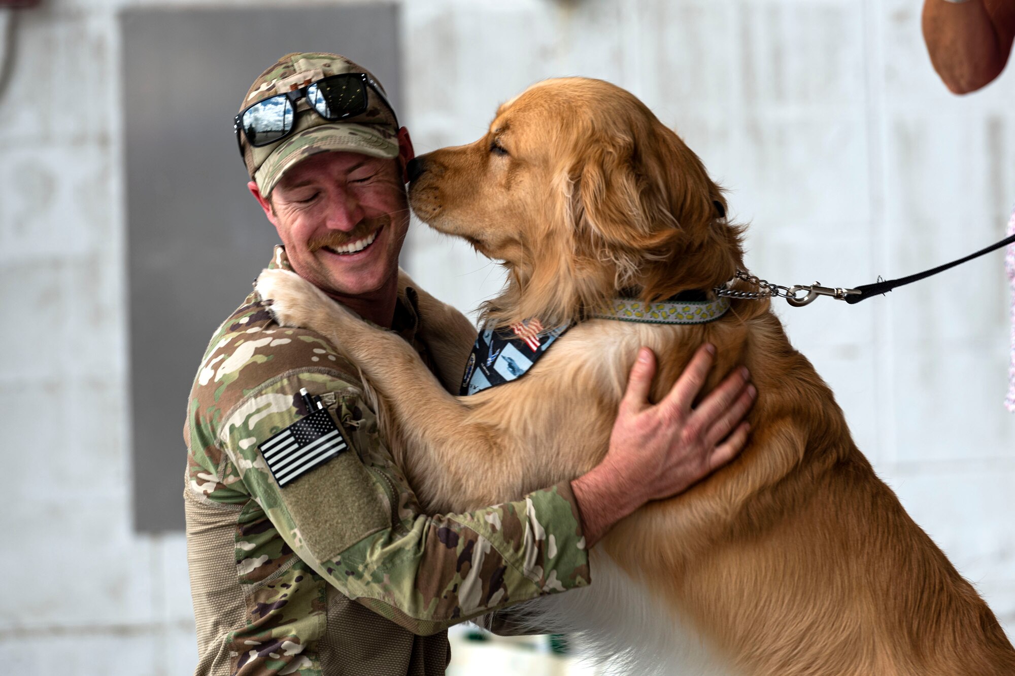 Photo of Airman reuniting with his dog.